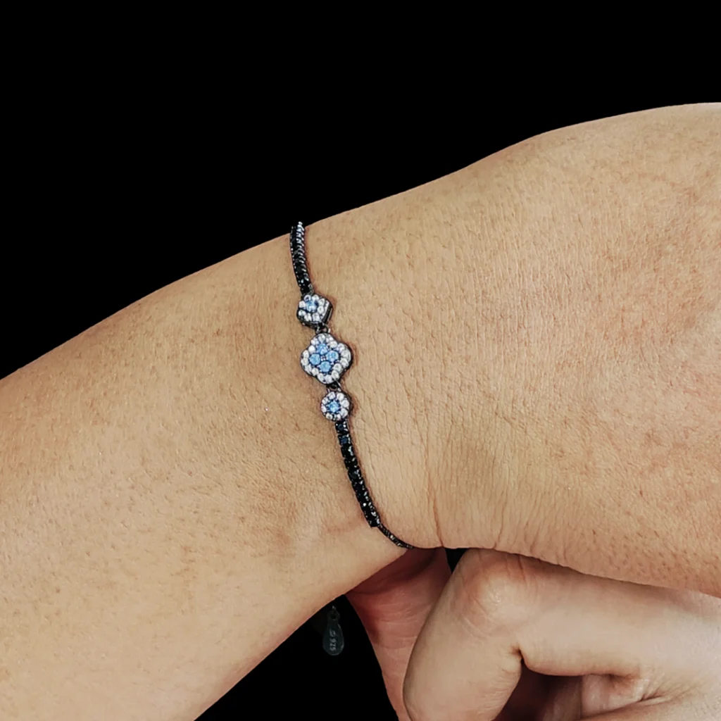 Black silver evil eye bracelet with flower-shaped blue and white zircon charms