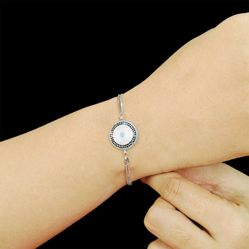 Mystic evil eye bracelet with blue, black, and white cubic zircon design and dual layered chain