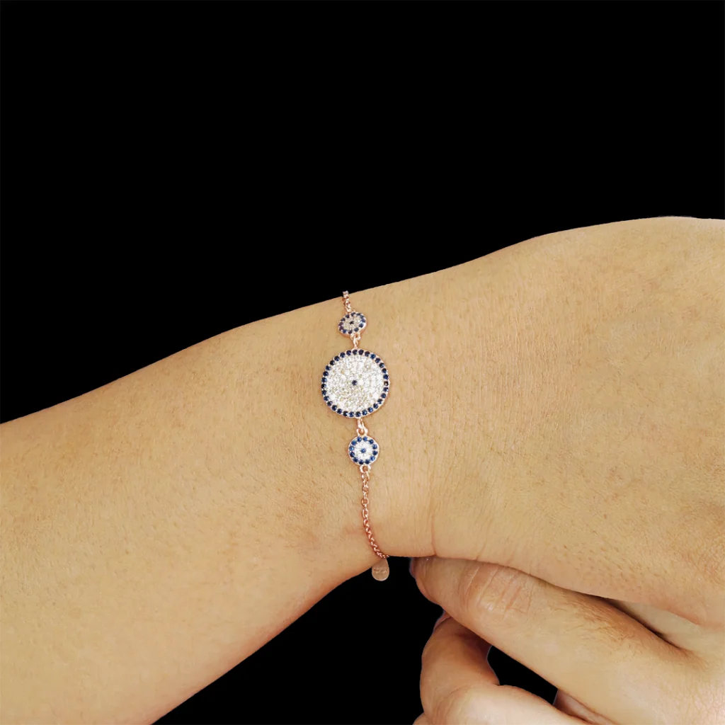 Rose gold evil eye bracelet with one large center and two smaller evil eyes on each side