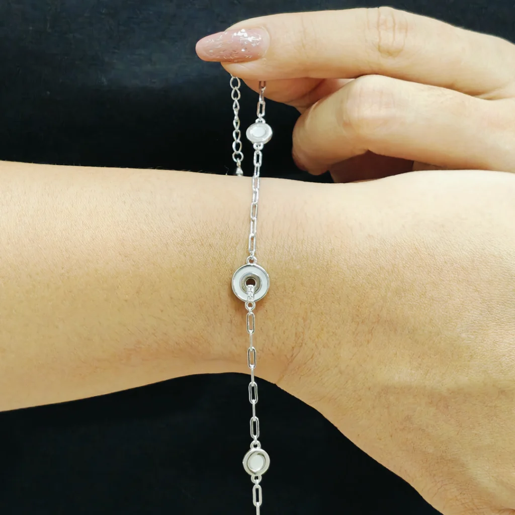 Silver bracelet with three circular mother of pearl moon-like charms