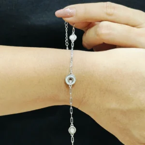 Silver bracelet with three circular mother of pearl moon-like charms