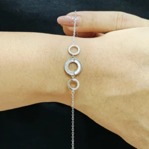 Minimal silver bracelet with three circular rings and a central mother of pearl