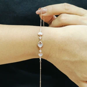 Rose gold bracelet with three heart-shaped mother of pearl charms and zircon accents
