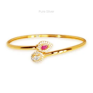 Gold polished ruby dew drop bangle with red and white stones and zircon detailing in twister design