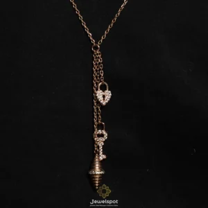 Sterling silver necklace with heart and key charms and white zircons