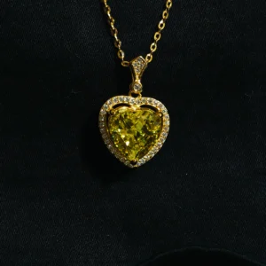 Lime heart pendant with green stone and zircons in gold finish on sterling silver chain.