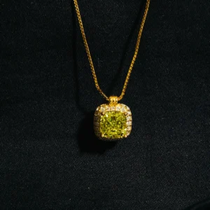 Cushion cut green pendant with zircons in gold finish on sterling silver chain.