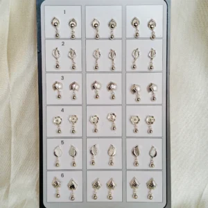 Assorted sterling silver minimal studs and drop earrings with hearts, pearls, keys, animals and more